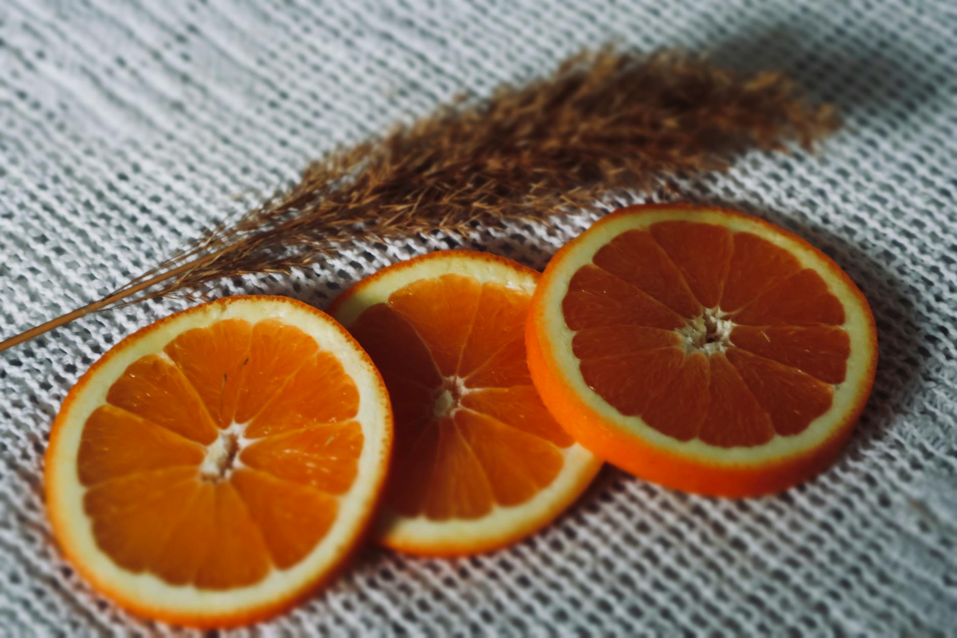 Plastry świeżej pomarańczy na tekstylnej tkaninie z naturalnymi dodatkami