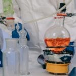 Chemicy w laboratorium wykonują doświadczenie z roztworami chemicznymi